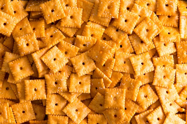 Background texture of square cheese crackers — Stock Photo, Image