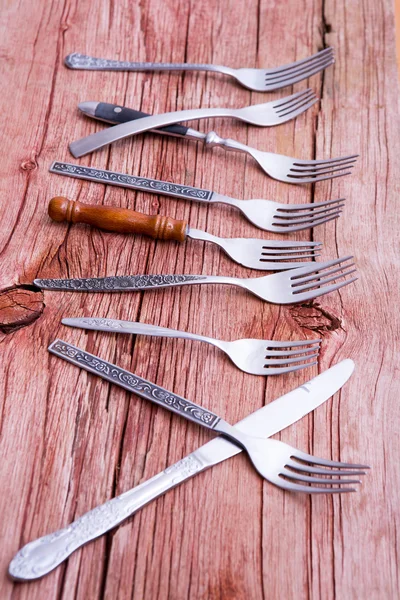 Array of rustic forks and a single knife — Stock Photo, Image