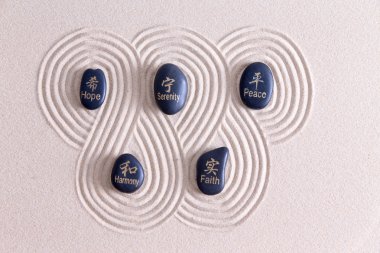 Zen art with stones on golden sand clipart
