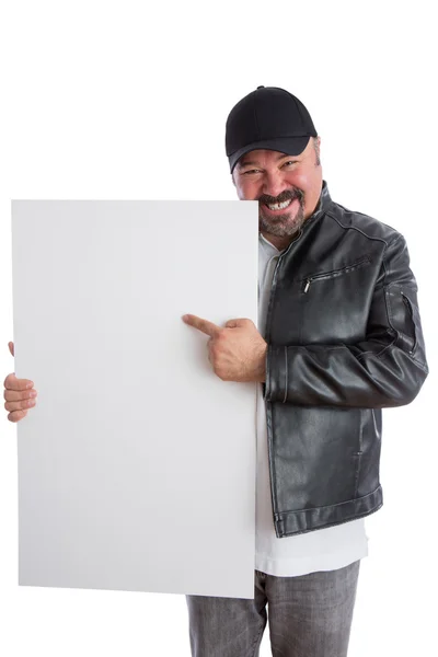 Charismatic man pointing to a blank white sign — Stock Photo, Image