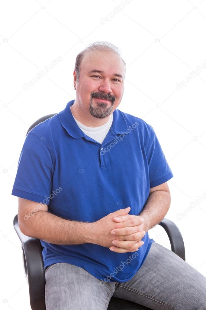 Admiring Bearded Man on a Chair Looking at Camera