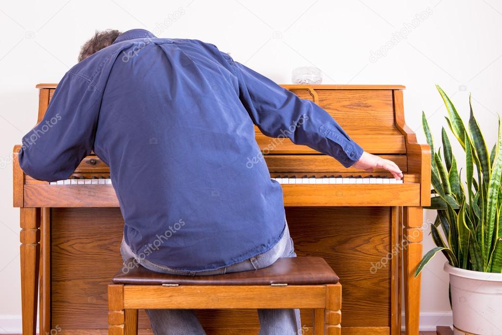Enthusiastic man playing the piano with gusto