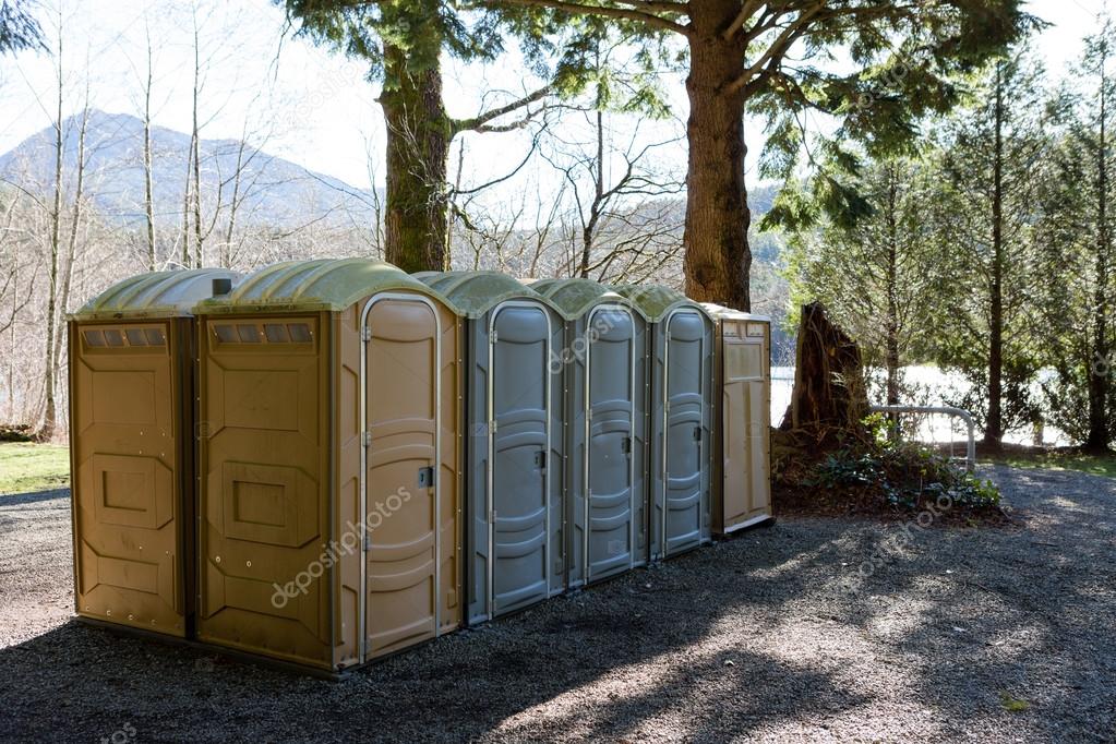 Row of public Portapotty toilets in a park