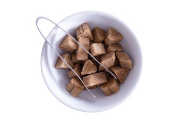 Brown sugar cubes in a bowl clipart