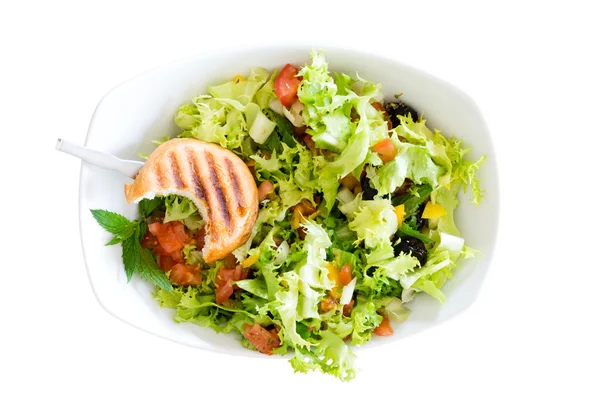 Fresh salad with a bitten toasted bun — Stock Photo, Image