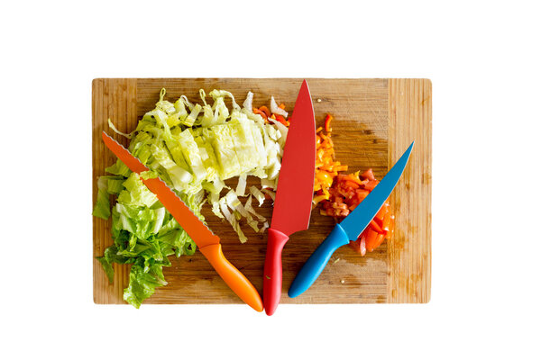 Knives on Cutting Board with Chopped Veggies