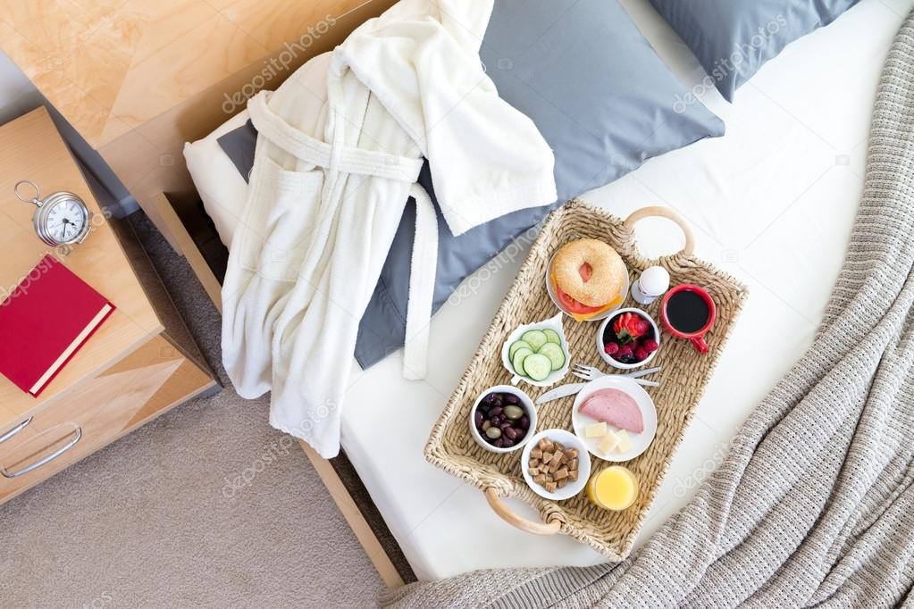 Bathrobe and Breakfast Tray on Unmade Bed
