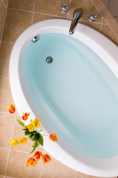 Oval bathtub filled with clean water — Stock Photo, Image