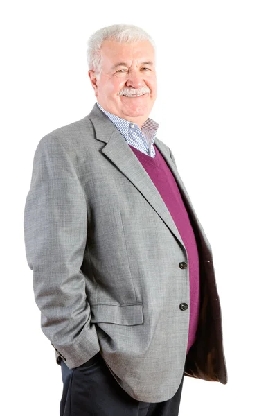 Senior-Geschäftsmann lächelt gegen Weiß in die Kamera — Stockfoto