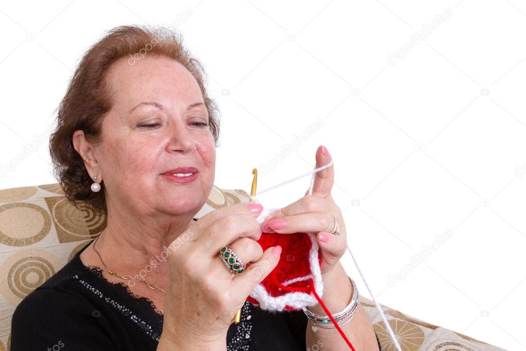 Elderly woman concentrating on her knitting