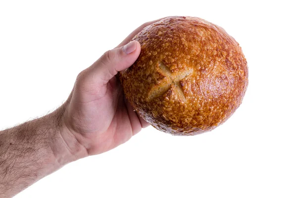 Male hand giving a sourdough bread roll — Stock Photo, Image