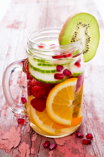 Fresh fruit and water filled mason jar — Stock Photo, Image