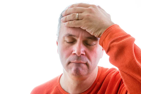 Forgetful man holding his hand to his forehead — Stock Photo, Image