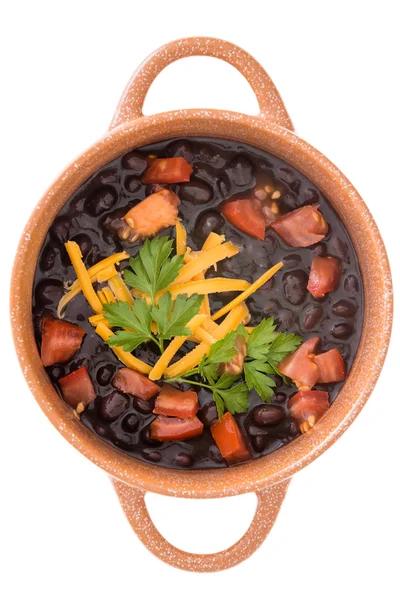 Bowl of black bean soup garnished with cheese — Stock Photo, Image