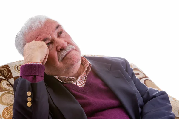 Elderly retired man relaxing in a chair — Stock Photo, Image