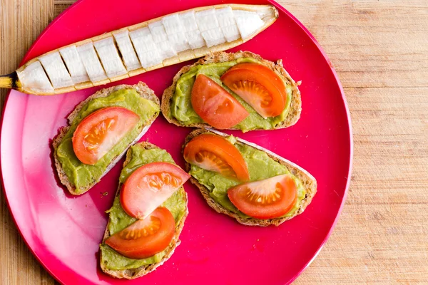 Sliced banana with four avocado sandwiches — Stock Photo, Image