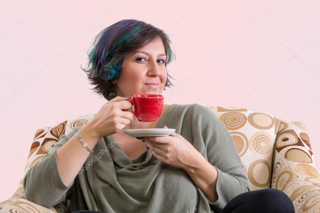 Intelligent adult female with red cup