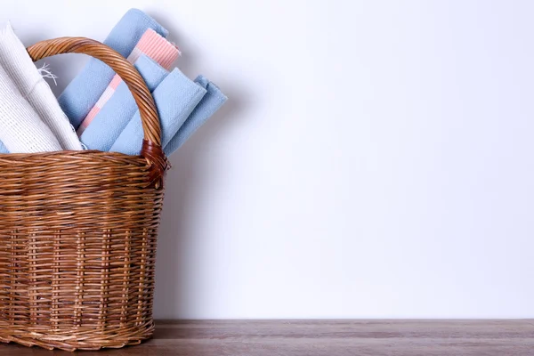 Worn Out Rugs in a Basket Against Empty White Wall — Stok Foto