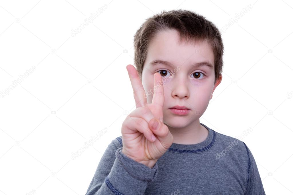 Serious boy with two fingers up