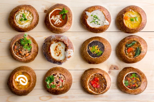 Twelve Soup Varieties Served in Bread Bowls