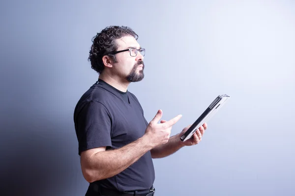 Thoughtful Man Holding Tablet and Counting on Hand — Stock Photo, Image