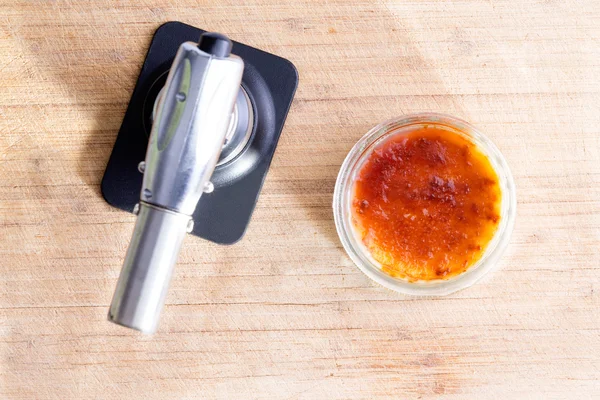 Freshly made creme brulee with a butane torch — Stock Photo, Image