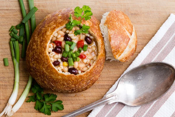 Top down view of bread bowl with green onions — Stock Photo, Image