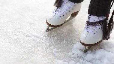 Artistik patinajda bacaklar yakın plan. Buzda kayan çocuk..