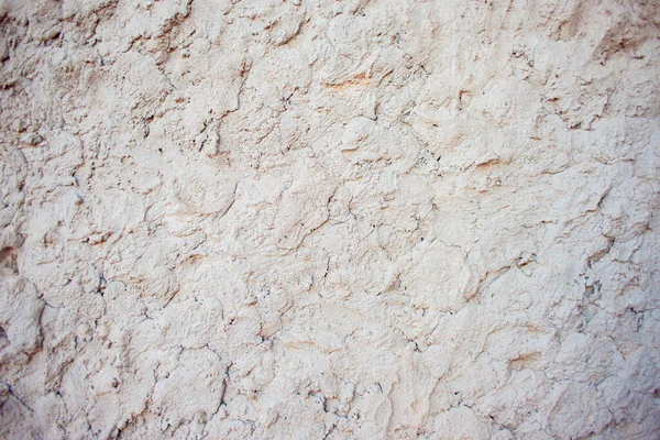 Abstract background of chaotically plastered cement on the wall. Cement pattern. Cement stucco molding on the walls of the building