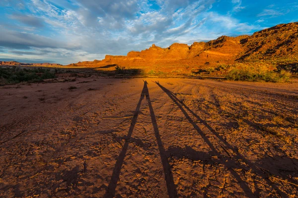 Long Shadow of two happy hikers raising their hands Sunset in th — Stock Photo, Image