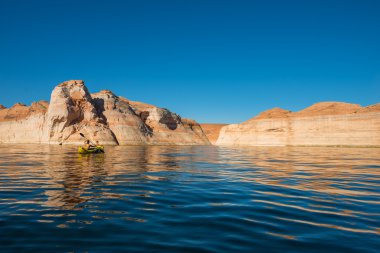 kayaker paddling the calm waters of Lake Powell Utah clipart