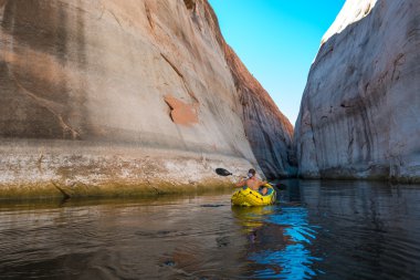kayaker paddling the calm waters of Lake Powell Utah clipart