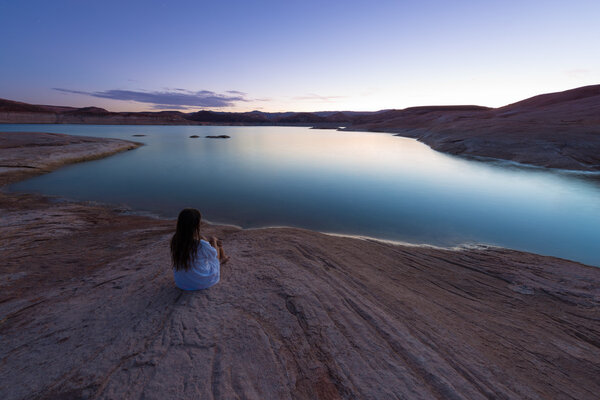 Single Woman sitting by the lake