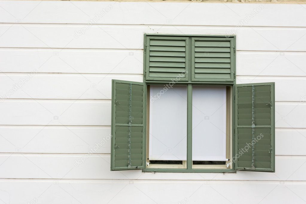 Green painted window frame with white wall