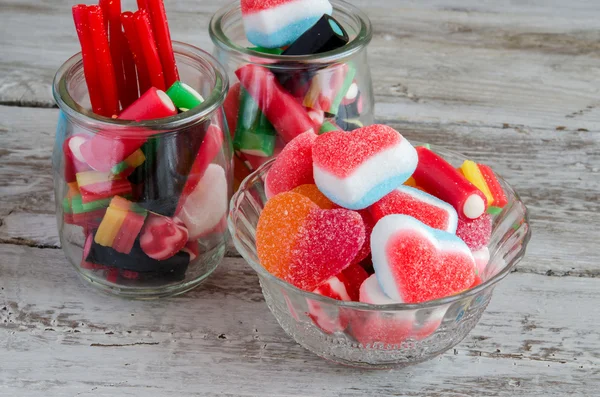 Surtido de dulces y caramelos en cuencos sobre mesa — Foto de Stock