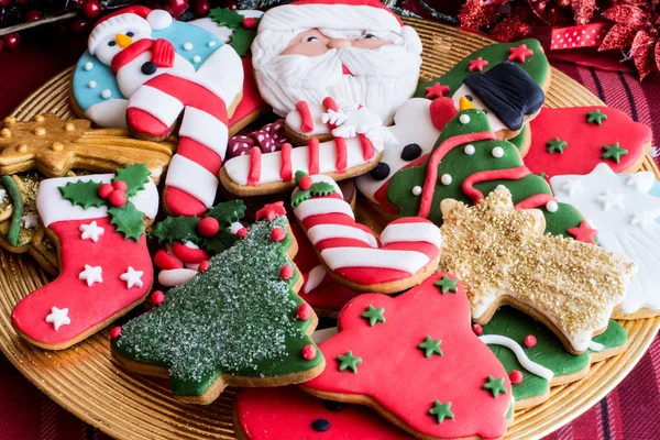 Decorated Christmas cookies on golden plate — Stock Photo, Image
