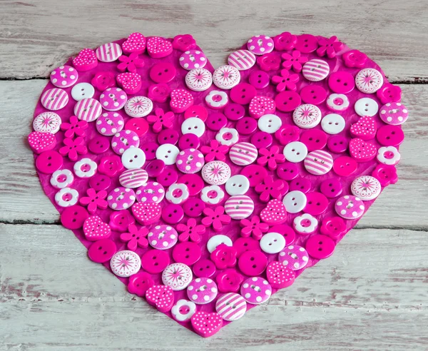 Pink heart covered with colorful buttons. — Stock Photo, Image