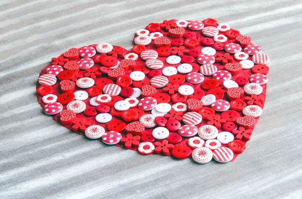 Red heart covered with colorful buttons. — Stock Photo, Image