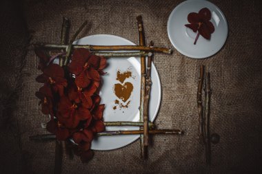 Dried flowers or craft flowers on old flax. Grunge background. R