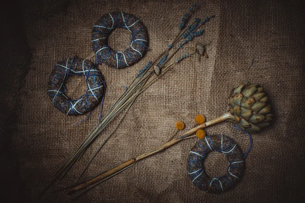 Dried flowers or craft flowers on old flax. Grunge background. — Zdjęcie stockowe