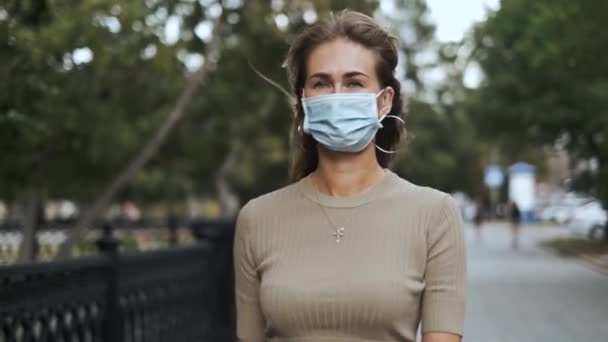Maskeli güzel bir kadın parkın koronavirüsünde yürüyor. Doğadaki insanlar covid-19 — Stok video