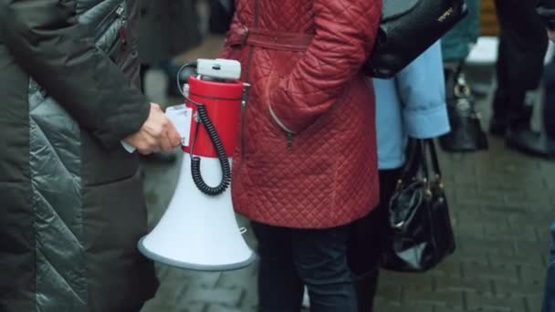 Political protest activists standing among rioting crowd. Megaphone in hand. — Stock Video