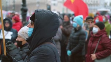 Elinde pankartıyla konuşan barışçıl bir protestocu. Salgın tecrit yürüyüşü.