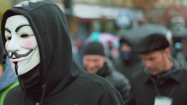 Eastern Europe protesting people mass. Marching anonym in Guy Fawkes mask. — Stock Video