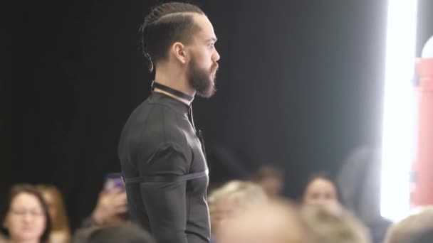 Bearded male model walks on runway podium. Men fashion. Vogue defile catwalk. — Stock Video