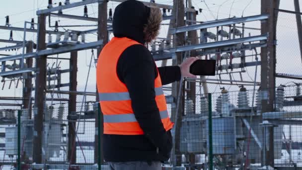 Electricista filmado con tablet PC en centrales eléctricas en invierno — Vídeo de stock