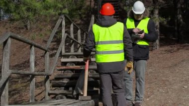 İşçiler yakın kırık ahşap parça konuşuyor 