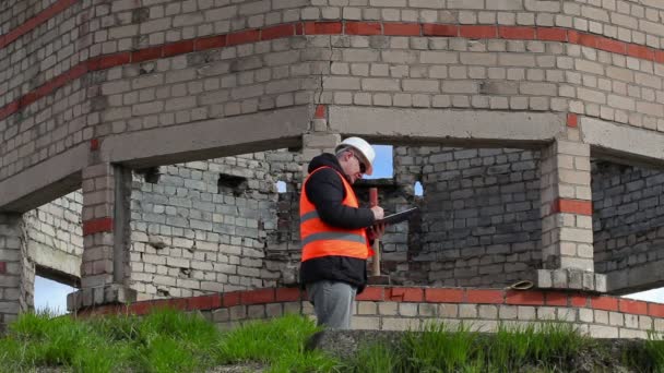 Burgerlijk ingenieur schrijven in de buurt van gebouw — Stockvideo