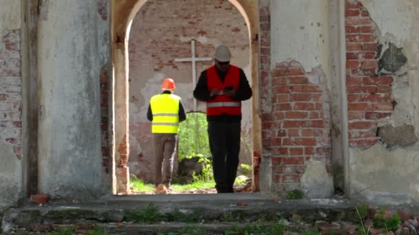 Building inspector take pictures on tablet PC at old church before restoration — Stock Video