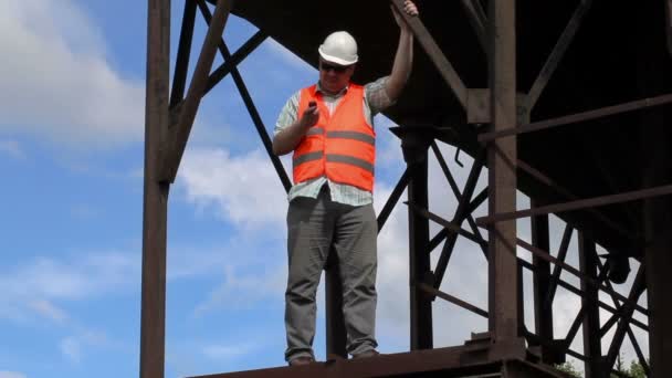 Worker using cell phone near tanks — Stock Video